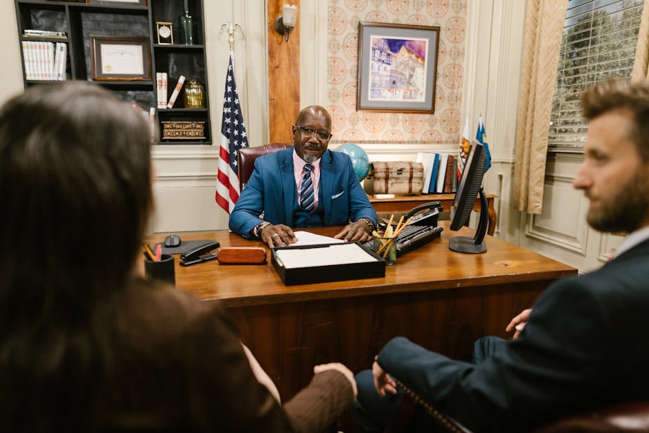 A professional lawyer meeting with clients in his office at a legal consultation