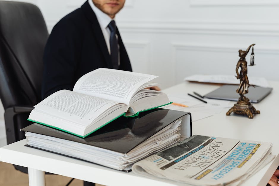 A lawyer sitting at a desk with legal books, documents, and a newspaper, embodying professionalism
